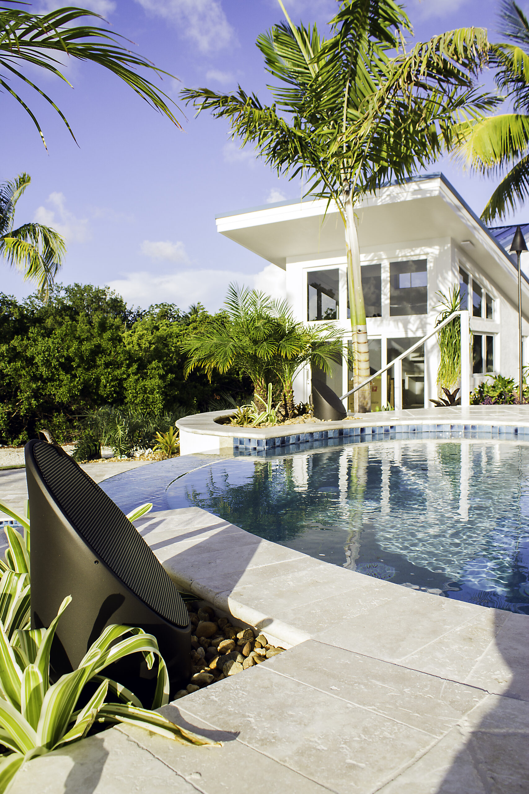 Coastal Source 2-Way Ellipse Bollard; close-up tropical pool deck at contemporary home Coastal Source Tampa outdoor audio outdoor speakers